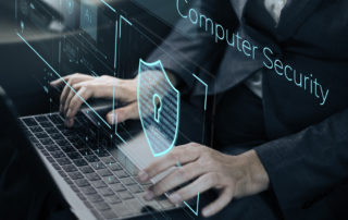 a man typing near a graphic that reads computer security